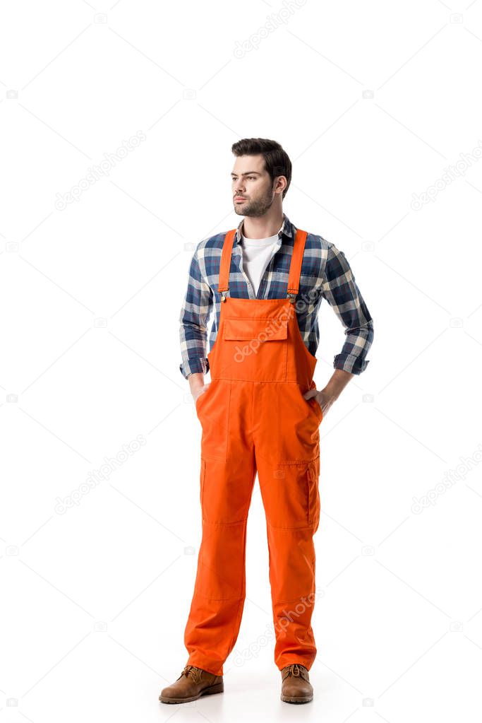 Young confident repairman in orange overall isolated on white