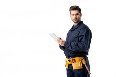 male plumber in uniform with digital tablet looking at camera isolated on white
