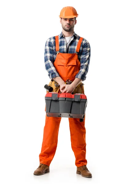 自信的修理工在橙色整体和硬帽子持有工具盒在白色隔离 — 图库照片