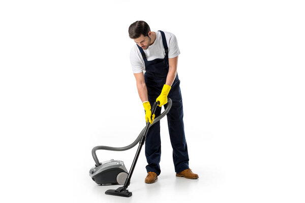 cleaner in uniform and rubber gloves with vacuum cleaner isolated on white