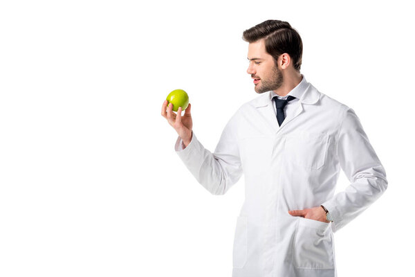 portrait of nutritionist in white coat with fresh apple in hand isolated on white