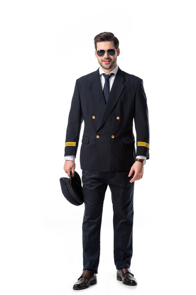 young bearded pilot in uniform and sunglasses isolated on white