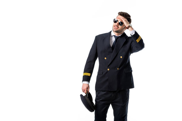 portrait of young pilot in sunglasses looking away isolated on white