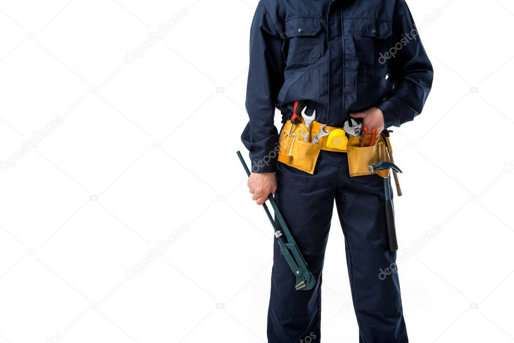 partial view of plumber in uniform with alligator wrench isolated on white