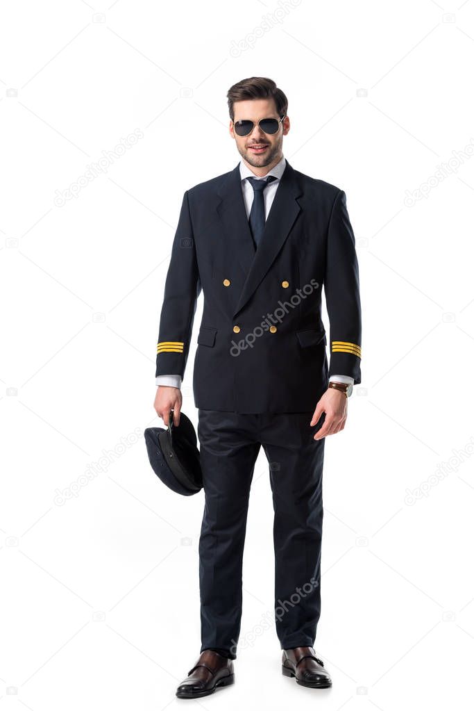 young bearded pilot in uniform and sunglasses isolated on white