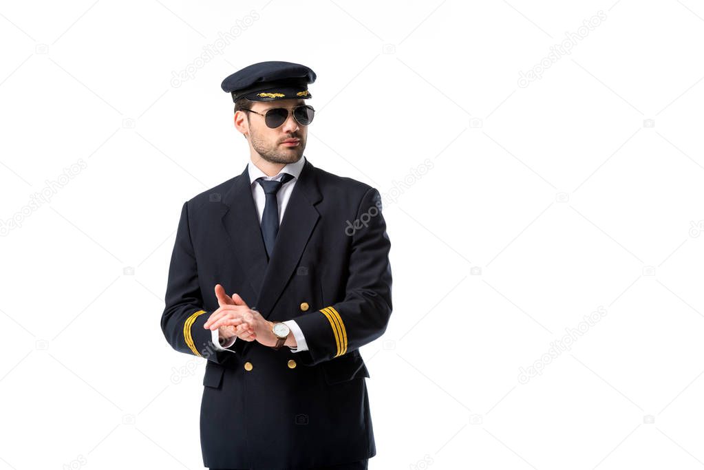 portrait of young pilot in sunglasses looking away isolated on white