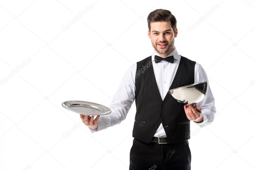 portrait of handsome bearded waiter in suit vest with empty serving tray isolated on white