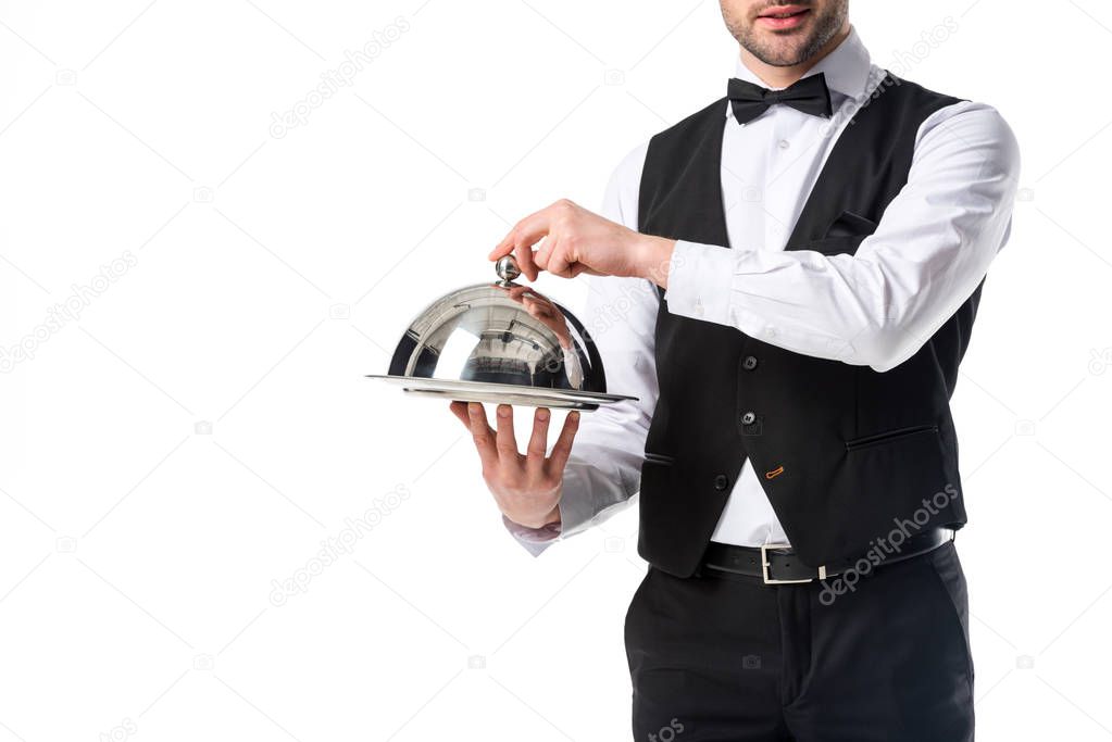 partial view of waiter in suit vest holding serving tray in hands isolated on white