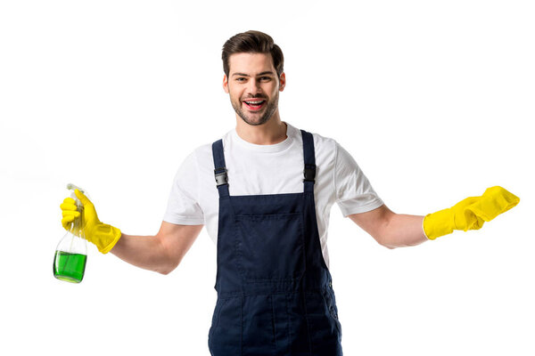 portrait of smiling cleaner in rubber gloves with cleanser and rag in hands isolated on white