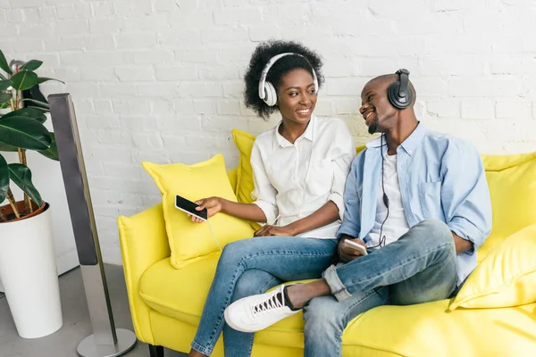 Smiling African American Listening Music Headphones Smartphones While Resting Sofa — Stock Photo, Image