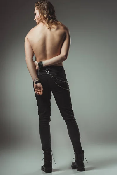 Back View Shirtless Man Standing Black Jeans Grey — Stock Photo, Image