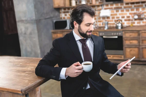 Widok Boku Samotnikiem Przystojny Biznesmen Patrząc Tablet Trzymając Kubek Kawy — Zdjęcie stockowe