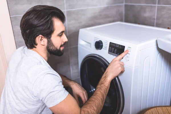 Handsome Loner Setting Washing Machine Program Bathroom — Stock Photo, Image