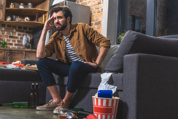 handsome loner having headache in morning at living room