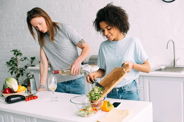 Young African American Woman Cooking Salad Boyfriend Pouring White Wine — Stock Photo, Image