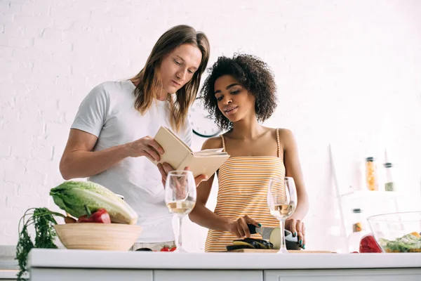 Young Multicultural Couple Looking Recipe Book Kitchen — Stock Photo, Image