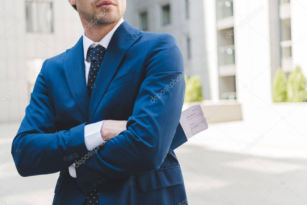 cropped shot of businessman in stylish blue suit with crossed arms