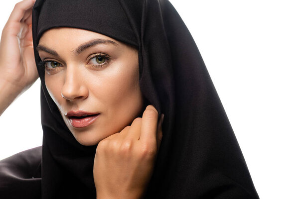 beautiful young Muslim woman in hijab with hands near face isolated on white