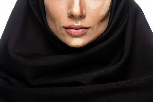 cropped view of young Muslim woman in hijab with facial contouring isolated on white