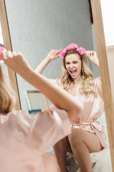 Selective Focus Excited Girl Touching Pink Hair Curlers Looking Mirror — Stock Photo, Image
