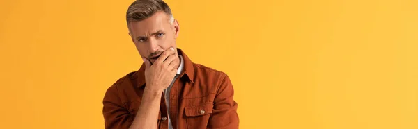 Panoramic Shot Pensive Man Touching Face Looking Camera Isolated Orange — Stock Photo, Image