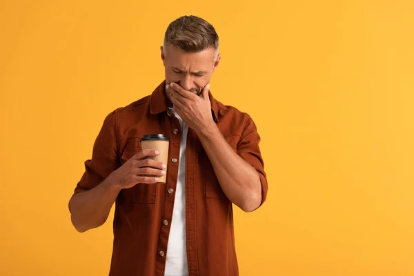 Sad Man Covering Face While Looking Paper Cup Isolated Orange — Stock Photo, Image