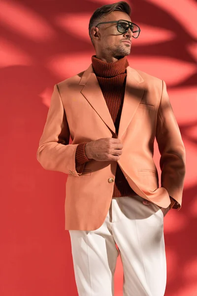 Fashionable Man Sunglasses Standing Hand Pocket Red Shadows — Stock Photo, Image