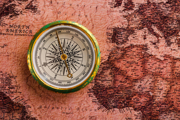 top view of golden compass near map 