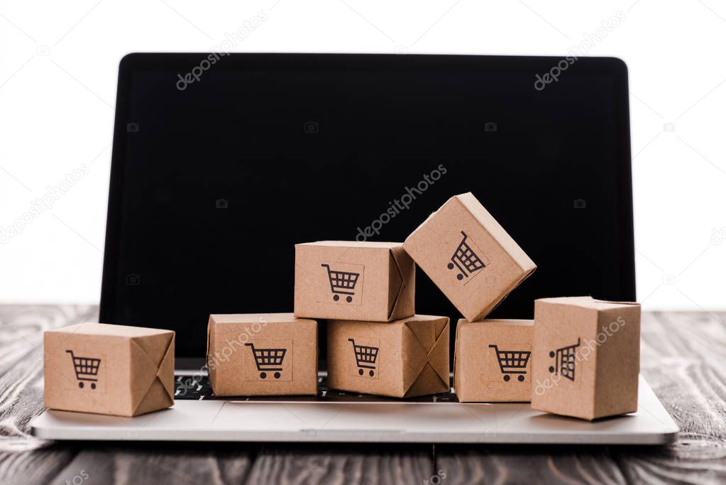 toy boxes on laptop with blank screen isolated on white, e-commerce concept