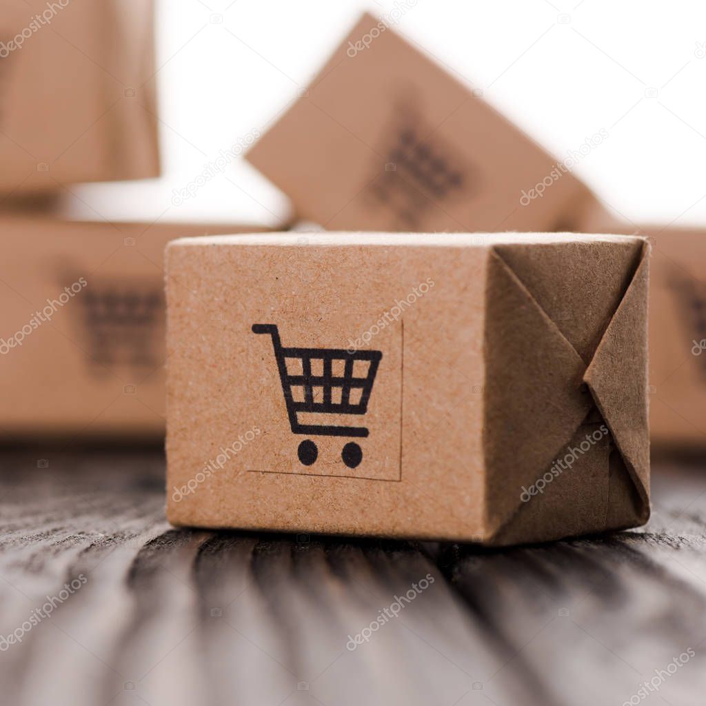 close up of small carton boxes on table isolated on white, e-commerce concept