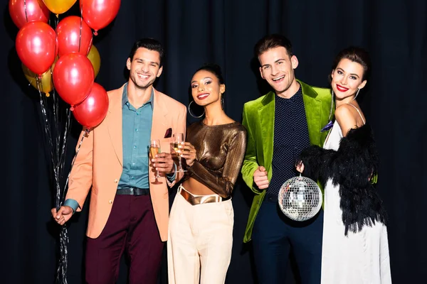 Happy Multicultural Women Handsome Men Holding Champagne Glasses Balloons Dark — Stock Photo, Image