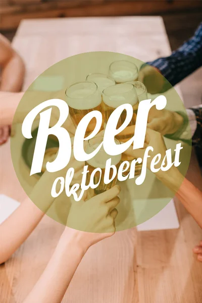 top view of fried sausages, onion rings, french fries, pretzels and mugs with beer on wooden table in pub with beer Oktoberfest illustration