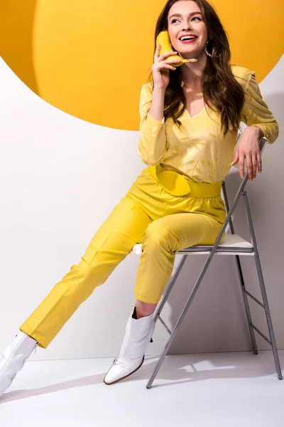 Happy Young Woman Sitting Chair Holding Banana White Orange — Stock Photo, Image