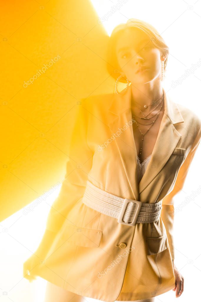 attractive woman looking at camera on white and yellow 