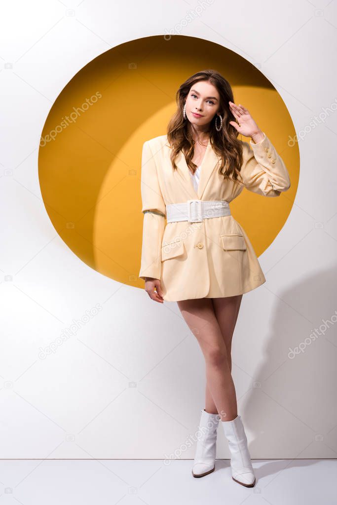 pretty young woman standing on orange and white 