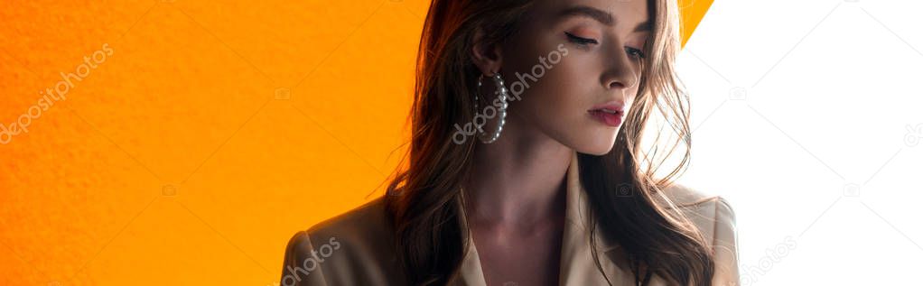 panoramic shot of young attractive woman on orange and white 