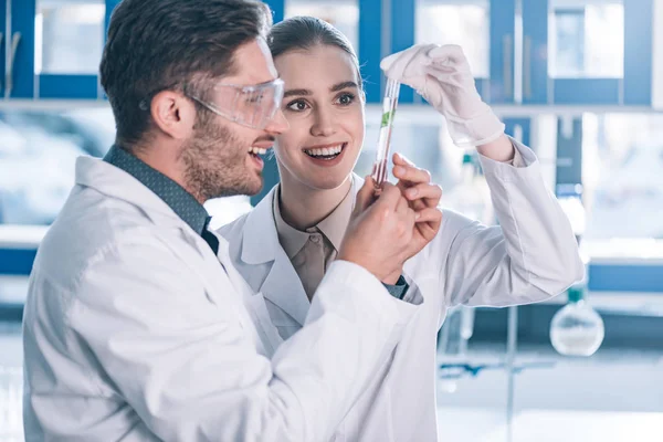 Happy Biochemists Looking Test Tube Green Plant Laboratory — Stock Photo, Image