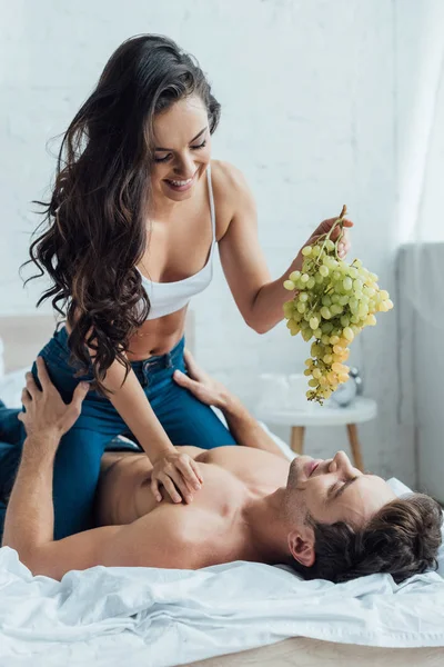 Sexy Smiling Woman Sitting Men Holding Bunch Grapes — Stock Photo, Image