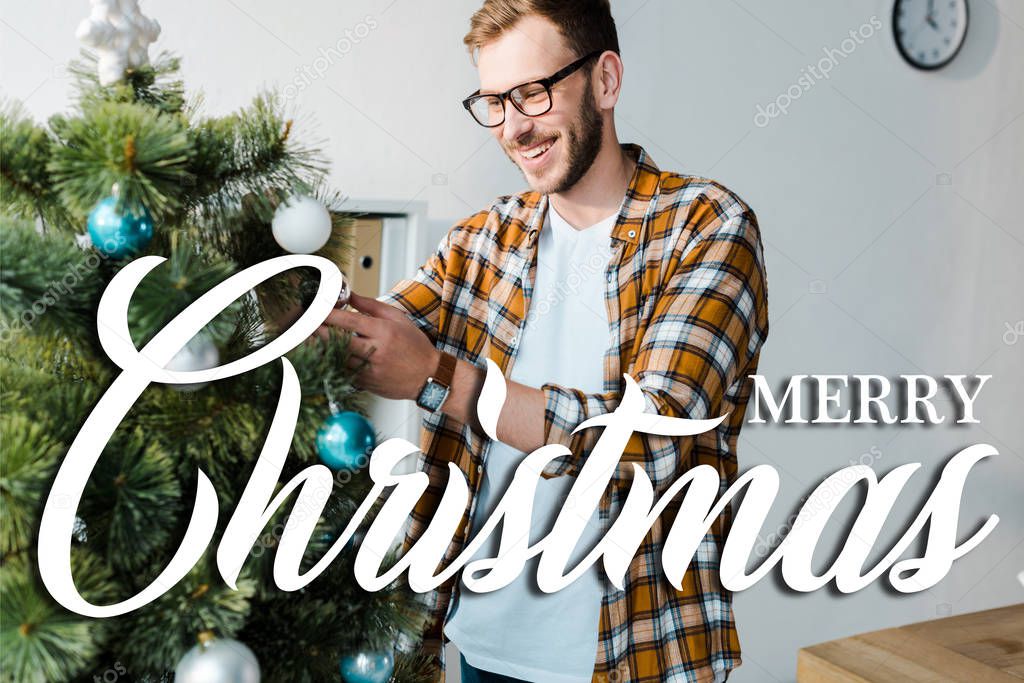 happy bearded man in glasses decorating christmas tree in office with merry christmas illustration 