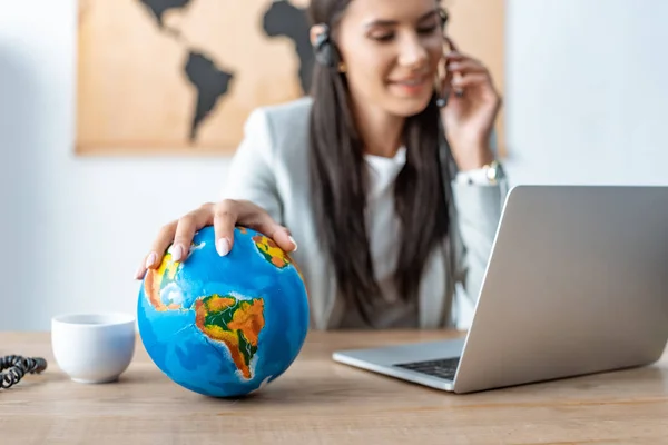 Selective Focus Travel Agent Holding Hand Globe While Working Workplace — Stock Photo, Image
