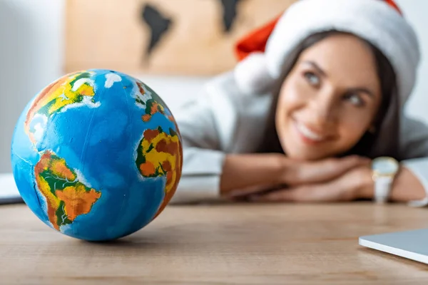 Smiling Dreamy Travel Agent Looking Away Globe Workplace — Stock Photo, Image