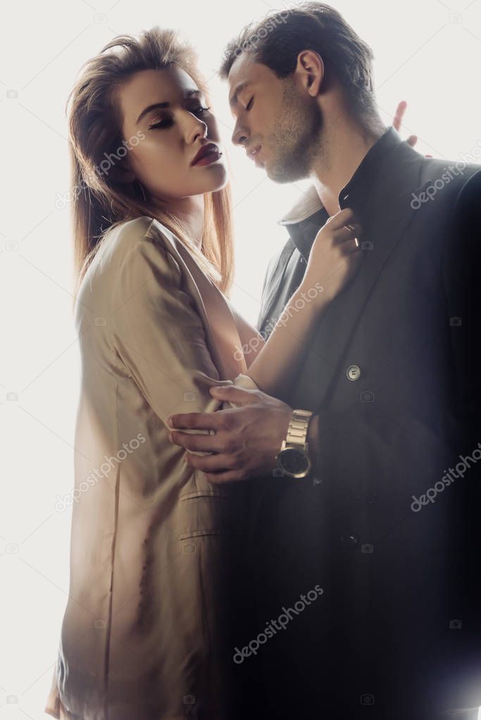 attractive woman hugging with handsome man isolated on white 