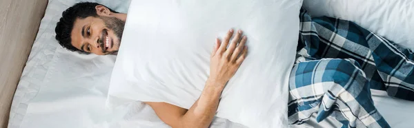 Panoramic Shot Handsome Smiling Racial Man Lying Bed Pillow Morning — Stock Photo, Image