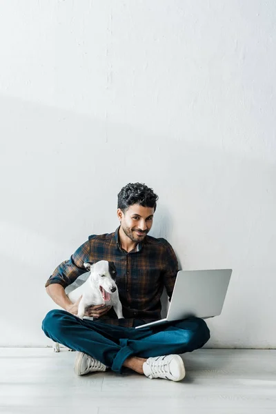 Handsome Smiling Racial Man Laptop Holding Jack Russell Terrier — Stock Photo, Image