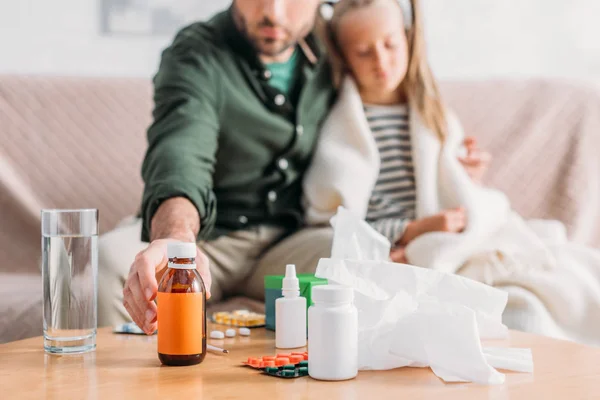 Selective Focus Father Taking Cough Syrup While Sitting Diseased Daughter — Stock Photo, Image