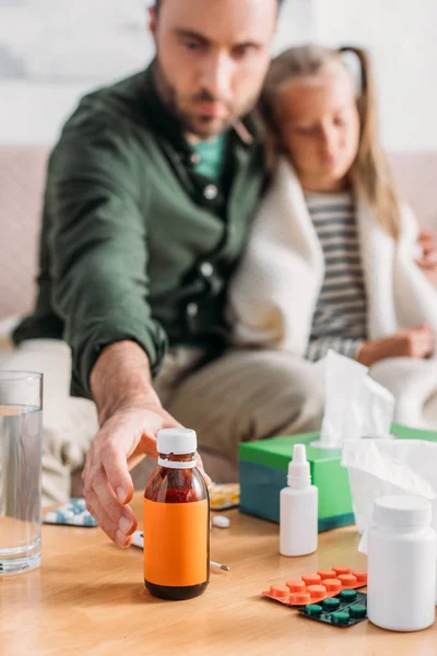 Selective Focus Man Taking Cough Syrup While Sitting Diseased Daughter — Stock Photo, Image