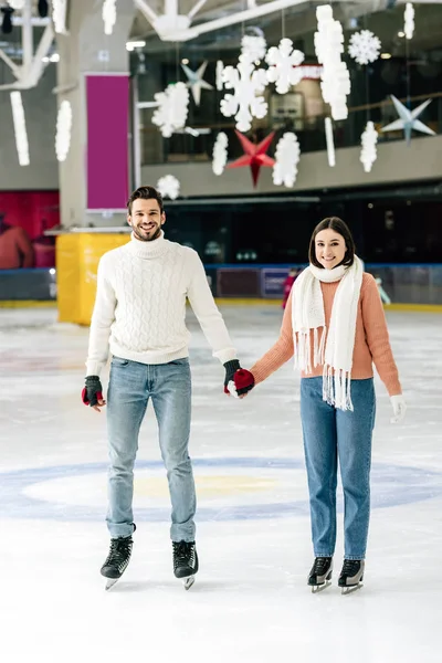 Sonriente Joven Pareja Cogida Mano Mientras Patina Pista — Foto de Stock