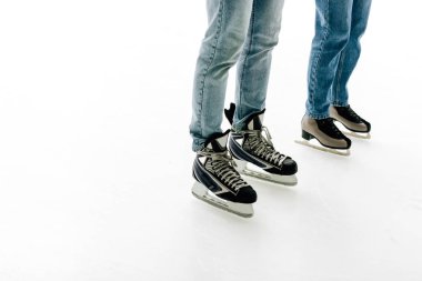 cropped view of young couple in skates skating on rink   clipart