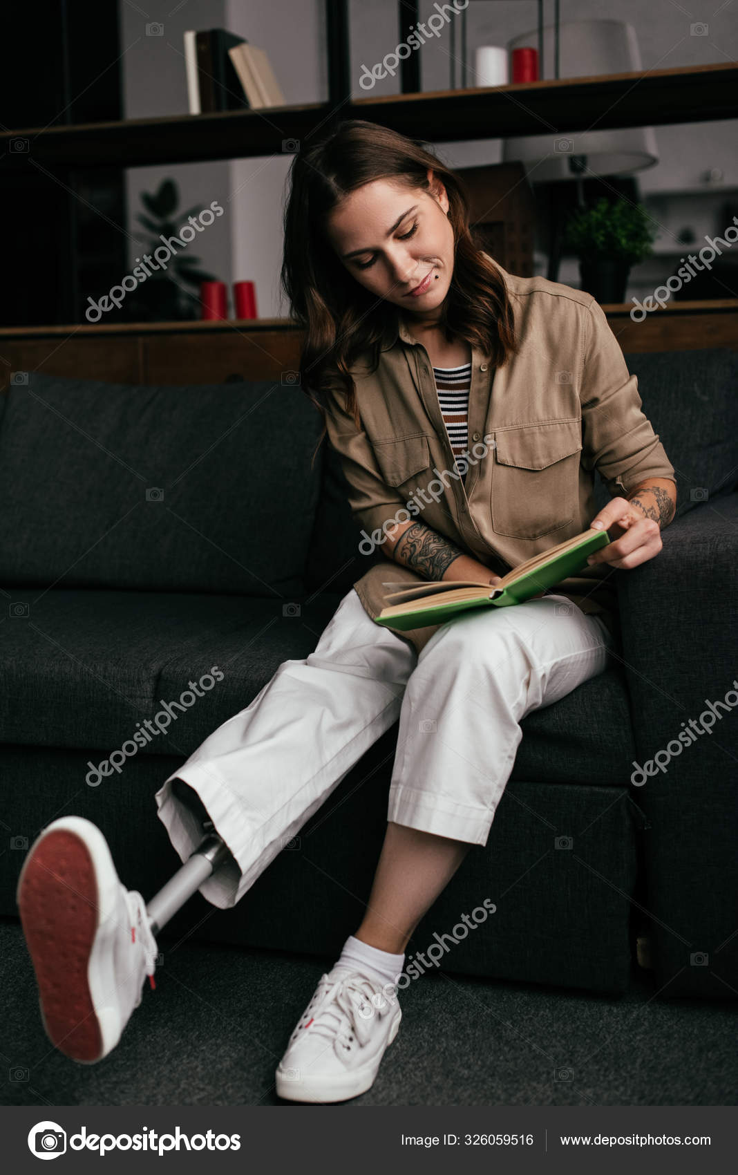 Beautiful Young Woman Prosthetic Leg Reading Book Sofa Living Room Stock  Photo by ©VitalikRadko 326059516
