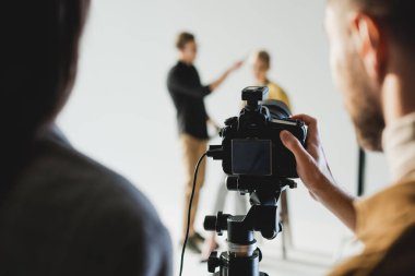 Yapımcı ve fotoğrafçının kuliste model ve saç stilistinin fotoğrafını çektiği seçici odak noktası 